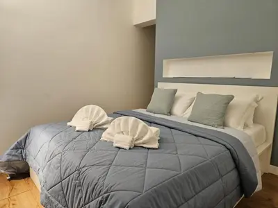 a bedroom with a bed with two towels on it at Be Your Home - Casa di Arya in Rome