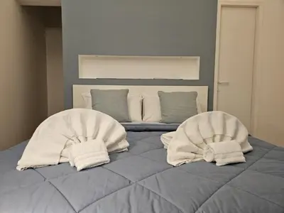 a bed with two white towels on top of it at Be Your Home - Casa di Arya in Rome