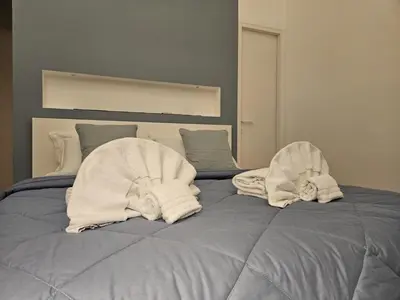a bed with two towels on top of it at Be Your Home - Casa di Arya in Rome