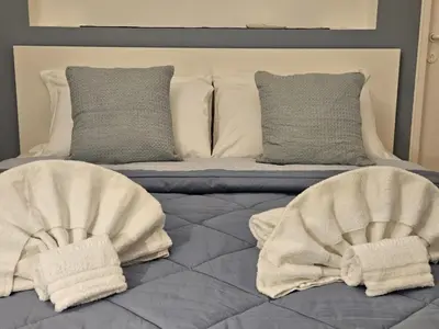 a bed with two pillows on top of it at Be Your Home - Casa di Arya in Rome