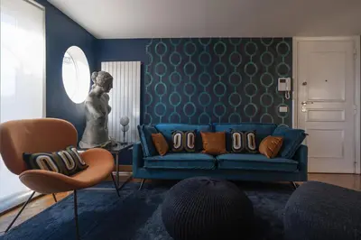 a living room with a blue couch and a statue at Terrazze di Venere in Rome