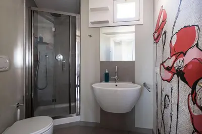 a bathroom with a sink and a shower and a toilet at Terrazze di Venere in Rome