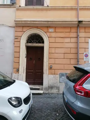 two cars parked in front of a building with a door at All'angolo di San Pietro - wifi in Rome