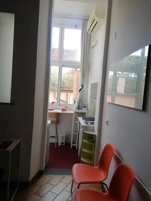 a room with two chairs and a table and a window at All'angolo di San Pietro - wifi in Rome