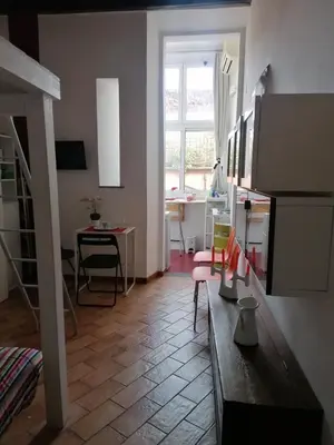a living room with a kitchen and a dining room at All'angolo di San Pietro - wifi in Rome