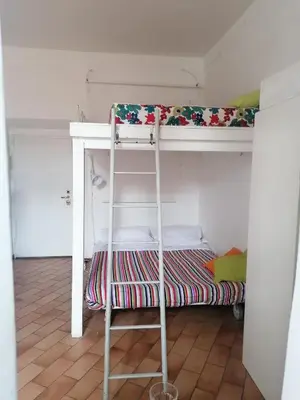 a bunk bed with a ladder in a room at All'angolo di San Pietro - wifi in Rome