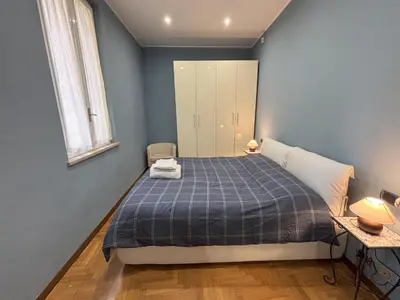 a bedroom with a bed with a blue blanket at Ai Quattro Cantoni in Rome