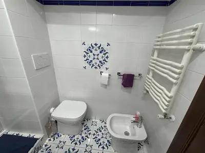 a small bathroom with a toilet and a sink at Ai Quattro Cantoni in Rome