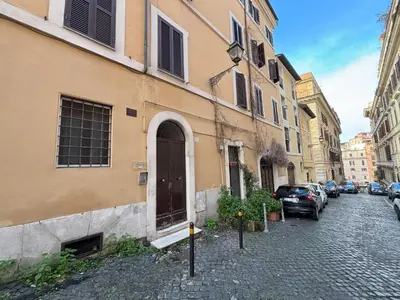 a street with cars parked next to a building at Ai Quattro Cantoni in Rome