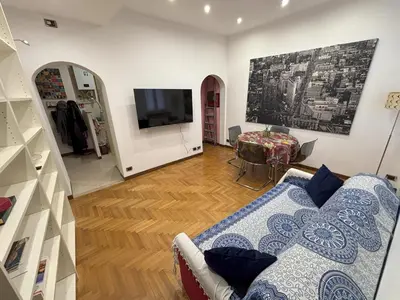 a living room with a couch and a tv at Ai Quattro Cantoni in Rome