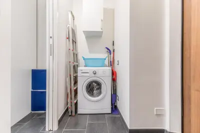 a small laundry room with a washer and dryer at Battistini Sweet Apartament in Rome