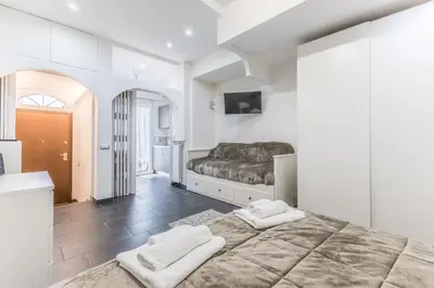 a bedroom with a large bed with two towels at Battistini Sweet Apartament in Rome
