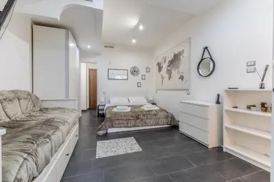 a bedroom with a bed and a desk at Battistini Sweet Apartament in Rome