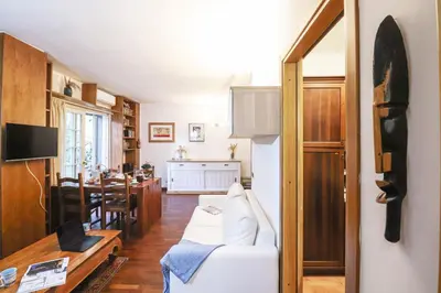 a living room with a white couch and a table at Casa del Koala al Gemelli Hospital in Rome