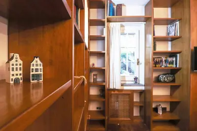 a living room with a white couch and a kitchen at Casa del Koala al Gemelli Hospital in Rome