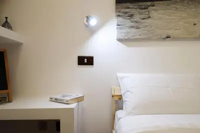 a living room with a dining room table and bookshelves at Casa del Koala al Gemelli Hospital in Rome