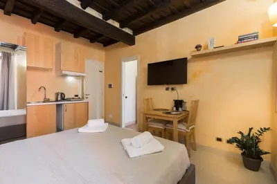 a room with a bed and a table with towels at Trinità Dei Monti in Rome