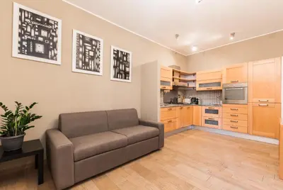 a living room with a couch and a kitchen at Trinità Dei Monti in Rome