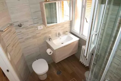 a bathroom with a sink and a toilet and a window at Pineta Domus in Rome