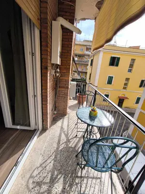 a table and chairs on the balcony of a building at Pineta Domus in Rome