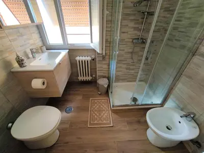 a bathroom with a shower and a toilet and a sink at Pineta Domus in Rome