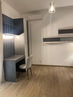 a office with a desk and a chair in a room at Pineta Domus in Rome