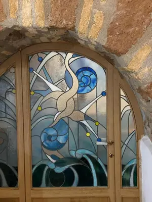 a glass door with two birds on the window at Roman times experience in Monti area in Rome