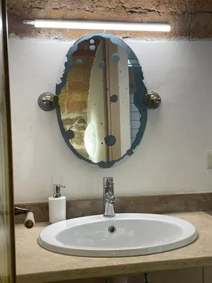 a bathroom sink with a large mirror above it at Roman times experience in Monti area in Rome