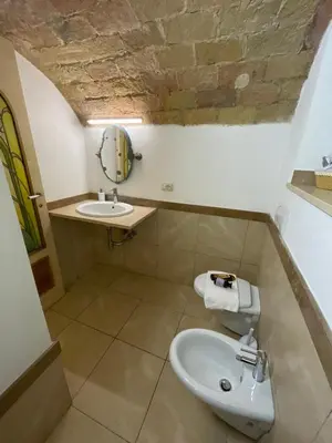 a bathroom with a sink and a toilet at Roman times experience in Monti area in Rome