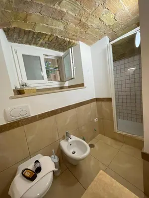 a bathroom with a sink and a toilet at Roman times experience in Monti area in Rome