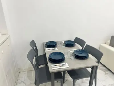a dining room table with blue dishes on it at Casa Justa Gregorio VII in Rome