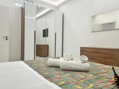 a bedroom with a large bed with towels on it at Casa Justa Gregorio VII in Rome