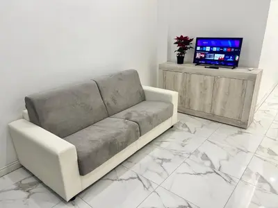 a living room with a couch and a tv at Casa Justa Gregorio VII in Rome