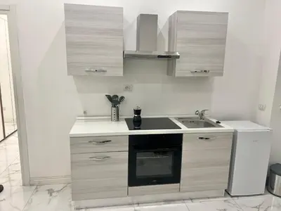 a white kitchen with a sink and a stove at Casa Justa Gregorio VII in Rome