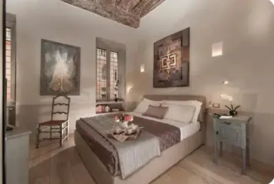 a bedroom with a bed with a table and a chair at Sophisticated apt near Navona square in Rome