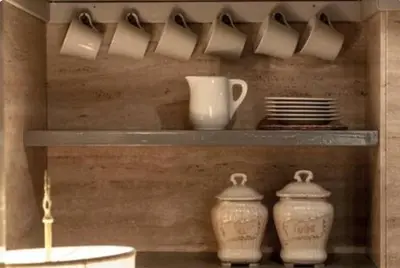 two vases on a shelf with cups and plates at Sophisticated apt near Navona square in Rome