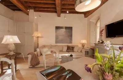 a living room with a couch and a tv at Sophisticated apt near Navona square in Rome