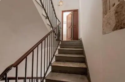 a hallway with stairs and a door in a building at Sophisticated apt near Navona square in Rome