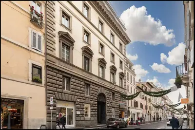 a building on the side of a city street at Luxury Apartment Spanish Steps in Rome