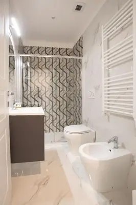 a white bathroom with a toilet and a sink at Appia - Regina Viarum B&B in Rome