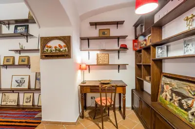 a home office with a desk and shelves at Atelier Colosseo, a Few Step from the Famous Arena in Rome