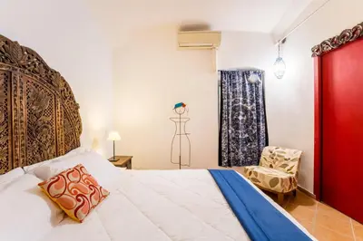 a bedroom with a large bed and a chair at Atelier Colosseo, a Few Step from the Famous Arena in Rome