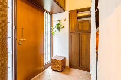 a hallway with a wooden door and a stool at Atelier Colosseo, a Few Step from the Famous Arena in Rome