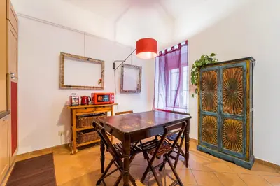 a dining room with a wooden table and chairs at Atelier Colosseo, a Few Step from the Famous Arena in Rome