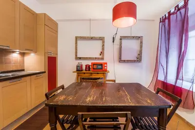 a dining room with a wooden table and chairs at Atelier Colosseo, a Few Step from the Famous Arena in Rome