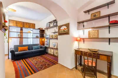 a living room with a blue couch and a table at Atelier Colosseo, a Few Step from the Famous Arena in Rome