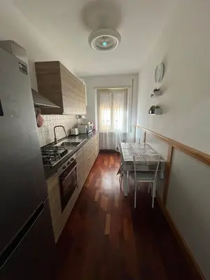 a kitchen with a table and a stove top oven at MichelleHouse in Rome