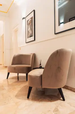 a living room with a couch and a chair at Whim Collection Vaticano Pra ti in Rome