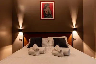 a bedroom with a bed with towels on it at Whim Collection Vaticano Pra ti in Rome