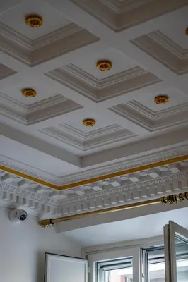 a coffered ceiling with gold accents in a room at Whim Collection Vaticano Pra ti in Rome
